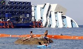 People sunbathe in front of the capsized cruise liner Costa Concordia ...