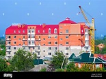 The building crane stands near a building house Stock Photo - Alamy