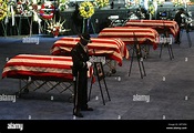 Officers stand guard at the caskets on Friday, March 27, 2009 at the ...