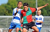 Two football players in action during the Cup match of : SC Buitenboys ...