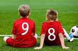 Young Football Players. Young Soccer Team Sitting on Grass. Boys in Red ...