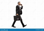 Businessman Walking and Talking on a Mobile Phone Stock Photo - Image ...