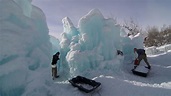 The workers digging out walk ways for visitors at an ice castle at a ...