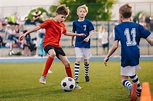 Young Boys Playing Soccer Game. Training And Football Match Betw - REP ...