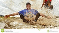Mud Run Man Slide Fun editorial photo. Image of feet - 57139451