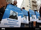 An Ukrainian man holds a poster with a portrait of Bogdan Nebylitsa (L ...