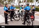 Florida, Miami Beach, Ocean Drive, police bicycle patrol, huddle, adult ...