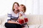 Mom gives daughter gift — Stock Photo © SergeyNivens #4162218