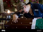 A woman reacts by the coffin containing the remains of Brazilian ...