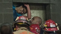 Rescuers free woman wedged between 2 buildings