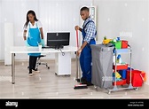 Young African Male And Female Cleaners Cleaning Office Stock Photo - Alamy