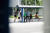 People waiting at bus stop - Stock Photo - Dissolve