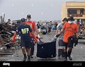 Rescuers carry bodies of typhoon victims they retrieved from the rubble ...