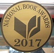 the national book awards logo is shown in black and gold on a round ...