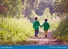 Two Boys Walking Forward On A Path With Back Facing Camera Royalty-Free ...
