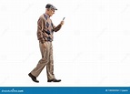 Senior Man Walking And Using A Mobile Phone Stock Photo - Image of ...