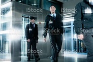 Security Guards Walking In Corridor Near Elevator Stock Photo ...
