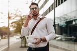 Man talking on cell phone while walking on street stock photo (157317 ...
