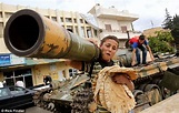 Free Syrian Army: A make-shift catapult and a child grinning by a tank ...