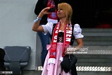 A Bayern Muenchen supporter in traditional Bavarian clothing `Dirndl ...