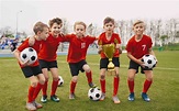 Happy Junior Sports Team. Young Boys in Soccer Team Holding Golden Cup ...