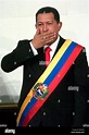 Venezuelan President Hugo Chavez, wearing a Venezuelan flag, sends a ...