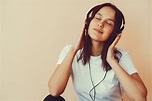 Dreamy young woman listening to music in headphones · Free Stock Photo