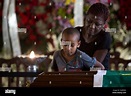 A woman holds her son by the coffin containing the remains of Brazilian ...