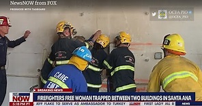 Naked woman freed between two buildings after rescue crews pull her out