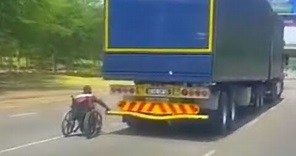 Man in wheelchair uses truck to boost him