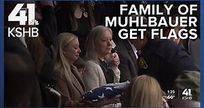 KCPD Officer James Muhlbauer s wife, son presented with flag during funeral ceremony
