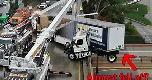 Big rig crashes and is left dangling off freeway bridge in Los Angeles!